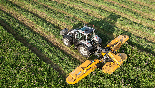 valtra tractor and twintrac on green field