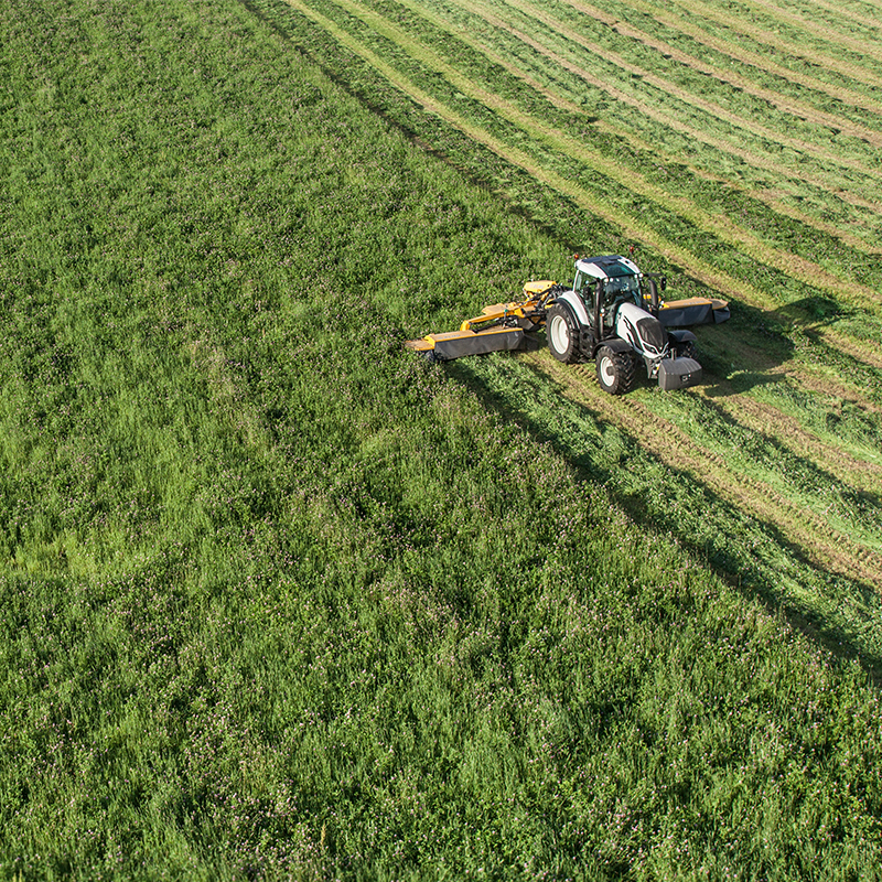 valtra tractor and twintrac on field